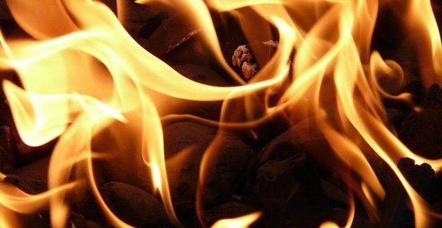 Close up image of a coal fire showing flames 