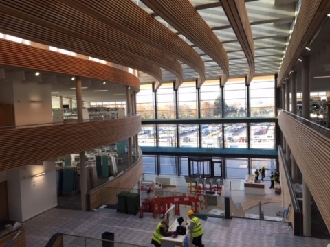 View down the length of UKHO building with timber slat walls and timber slat ceilings